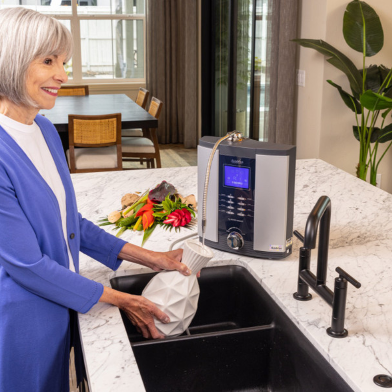 Woman getting water for her flower vase from a Alkaviva Athena H2 Hydrogen water ionizer 