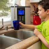 Male kid getting drinking water from a Alkaviva Athena H2 Hydrogen water ionizer 